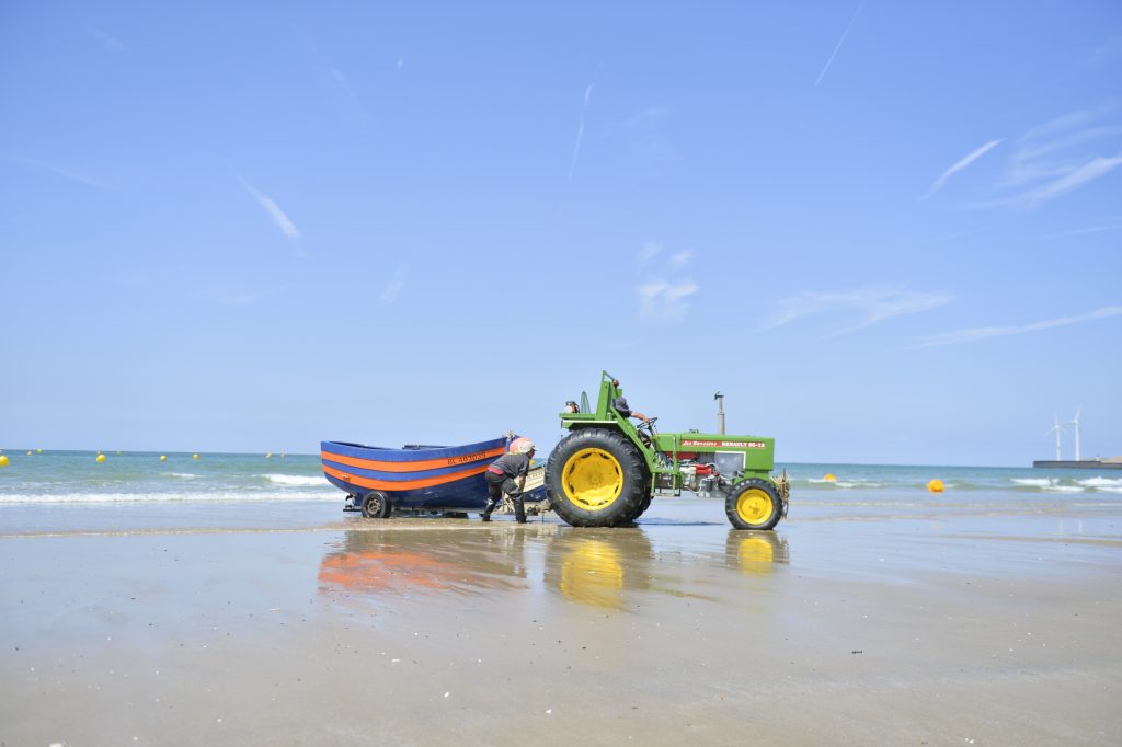 A traditional flobart  fishing boat pulled by a tractor at Le Portel beach
